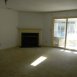 living room/dining room with firelpace, sliding doors to enclosed sun room